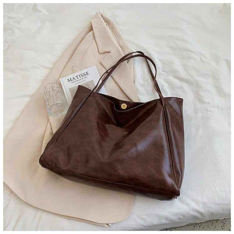 Premium faux leather shoulder bag in various colors, featuring a classic silhouette and roomy interior for everyday convenience.