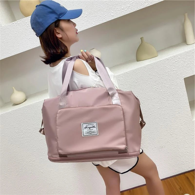 Expandable travel duffel bag with adjustable shoulder strap, multiple interior pockets, and water-resistant Oxford cloth material