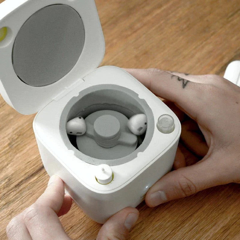 Automatic earbuds cleaning kit for AirPods, featuring a specialized chamber and cleaning mechanisms to thoroughly remove dirt and wax buildup