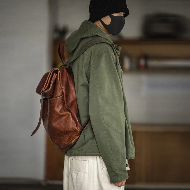 Rugged military-style windbreaker jacket for men, featuring a hooded design, cotton construction, and a classic, streamlined silhouette.