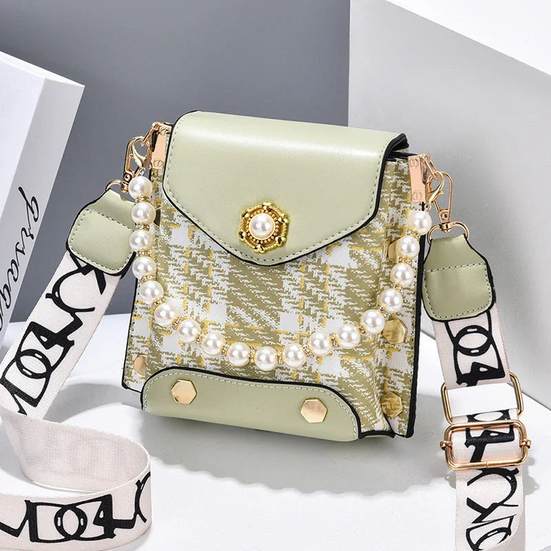 Premium crossbody phone bag with elegant pearl charm, made of durable PU leather and available in multiple color options
