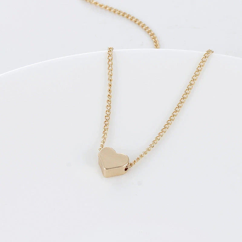 Elegant gold-tone double-sided love pendant necklace with a sleek clavicle chain design