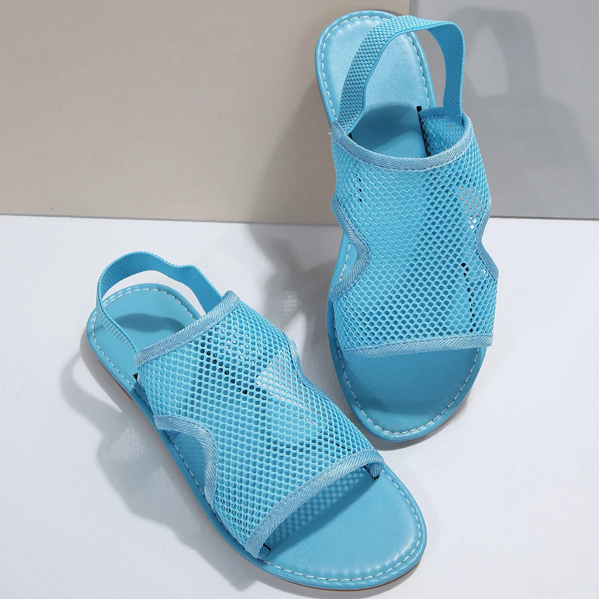 Breathable mesh sandals in various colors, featuring a lightweight design for summer comfort and style