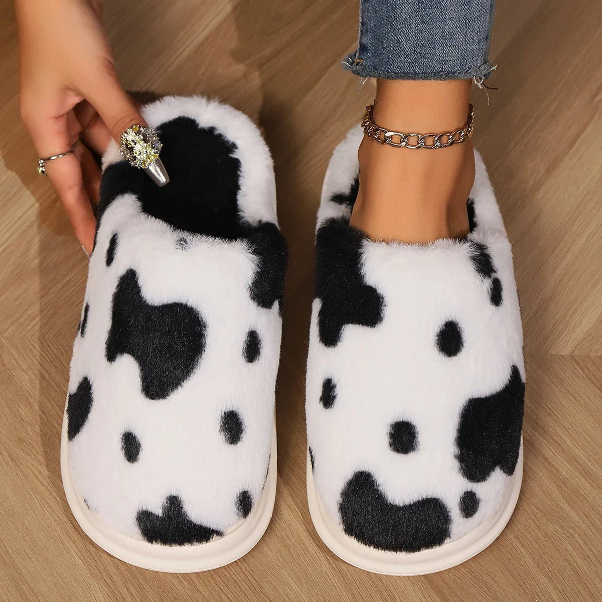 Cozy cow print plush slippers with a non-slip sole, perfect for indoor comfort and warmth