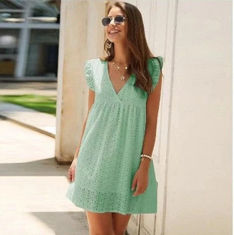 A stylish cotton mini dress with a v-neck and ruffled sleeves, perfect for summer days and nights.