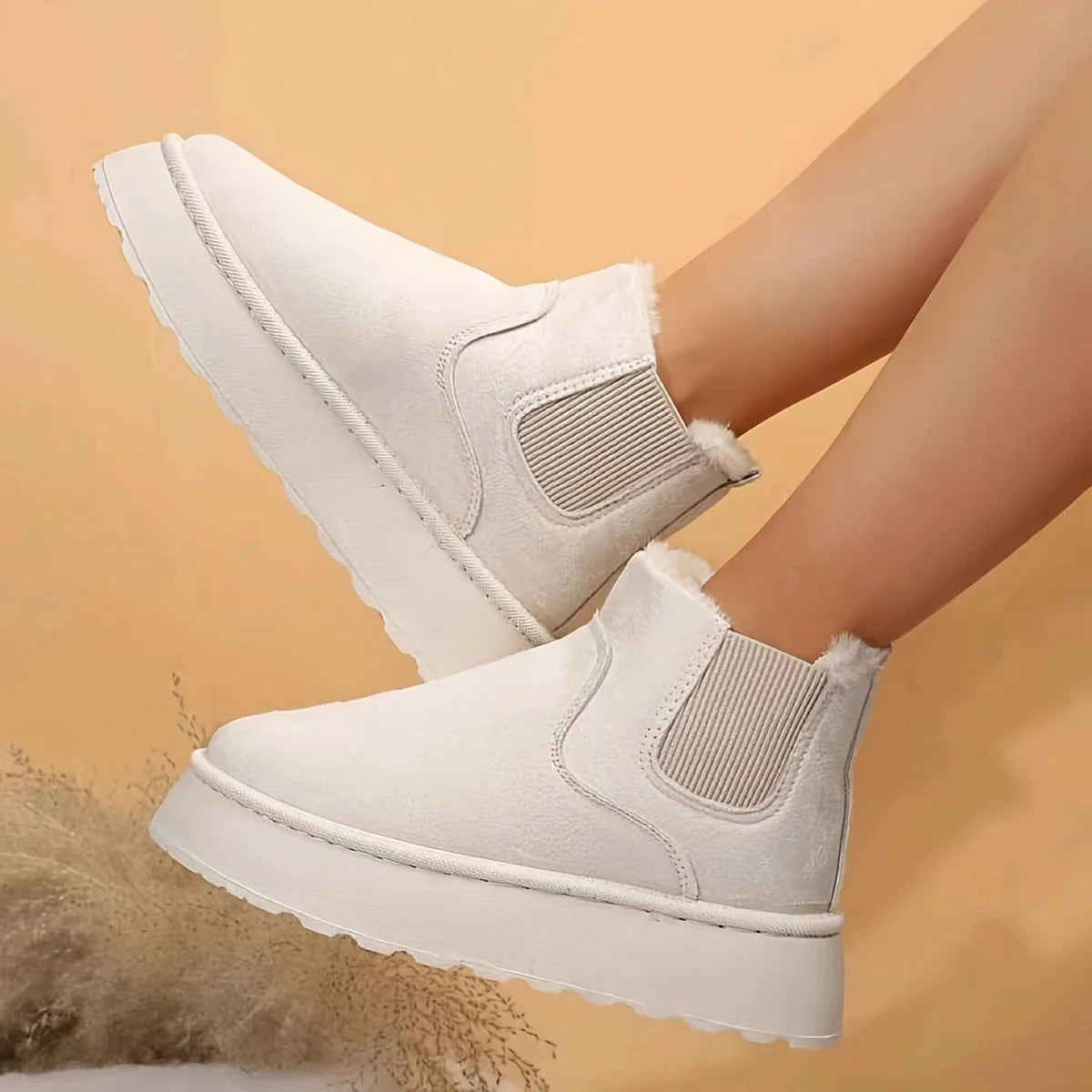 Stylish women's winter snow boots in various colours, featuring a thick sole and plush lining for warmth.
