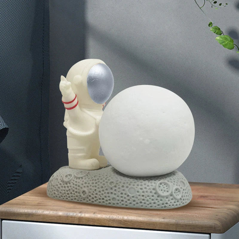 Astronaut-themed colour-changing night lamp with durable natural resin construction