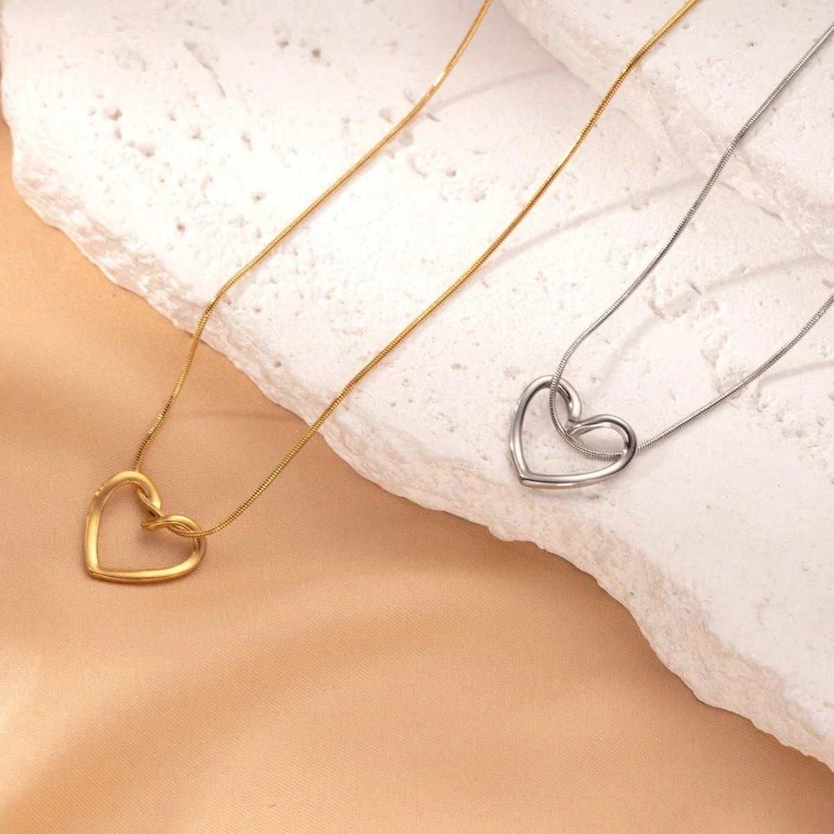 Titanium steel heart pendant necklace in gold and silver finishes, featuring an elegant and adjustable design for a customized fit