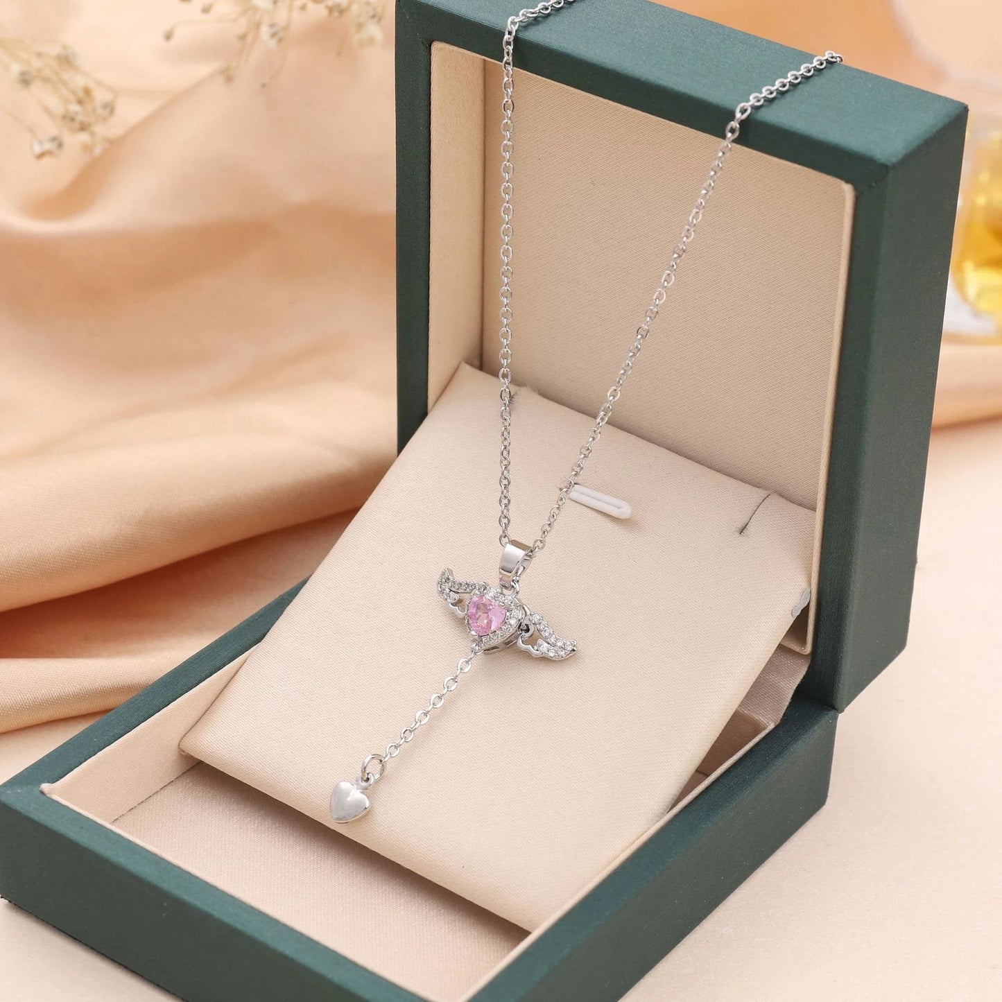 Enchanting necklace with Cupid heart and fluttering angel wings, crafted with titanium steel and sparkling zircon crystals