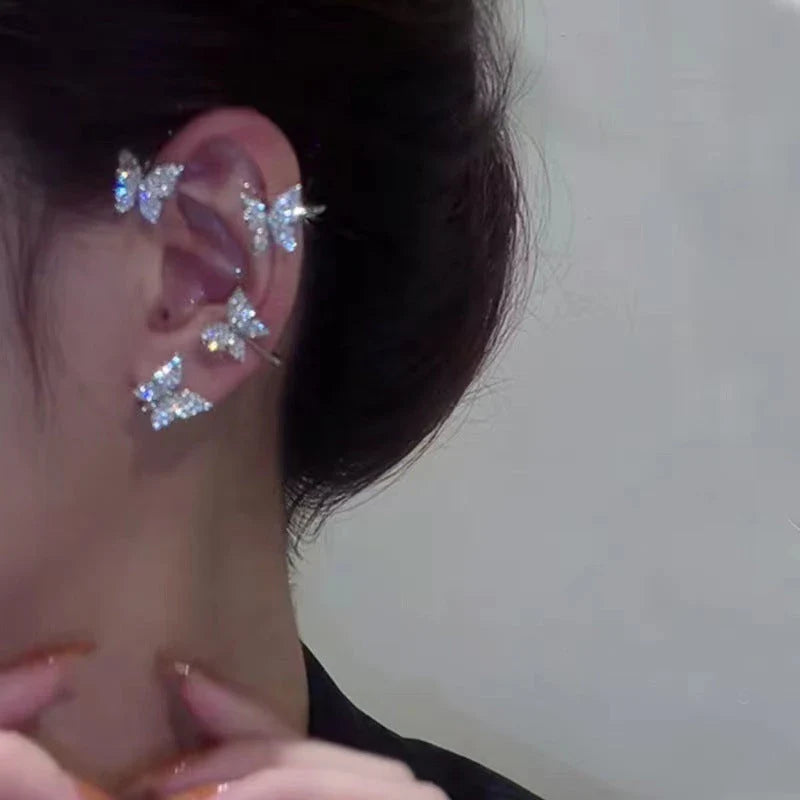 Chic butterfly ear clips in gold and silver tones, featuring a unique and elegant design for fashion-forward style.