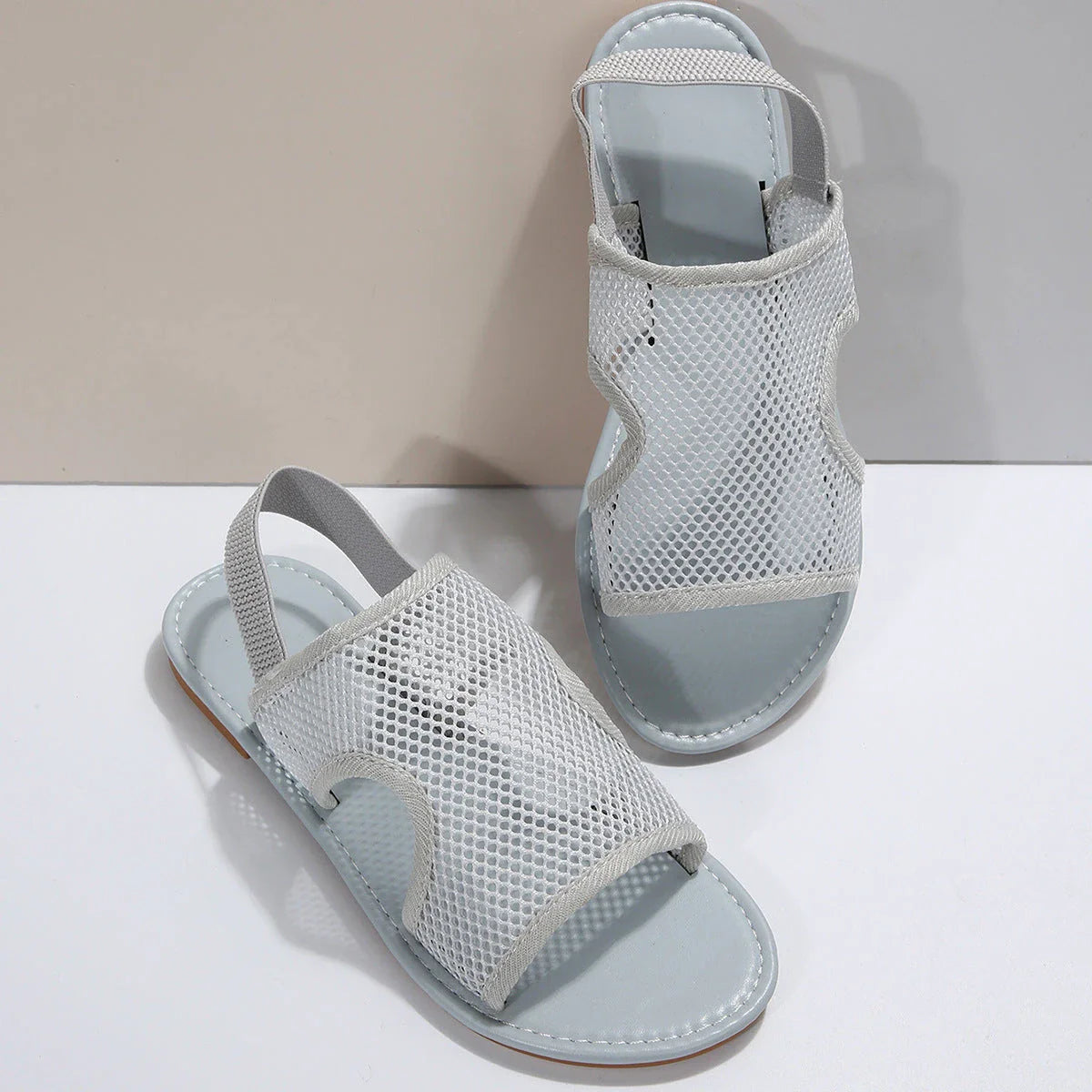 Breathable mesh sandals in various colors, featuring a lightweight design for summer comfort and style