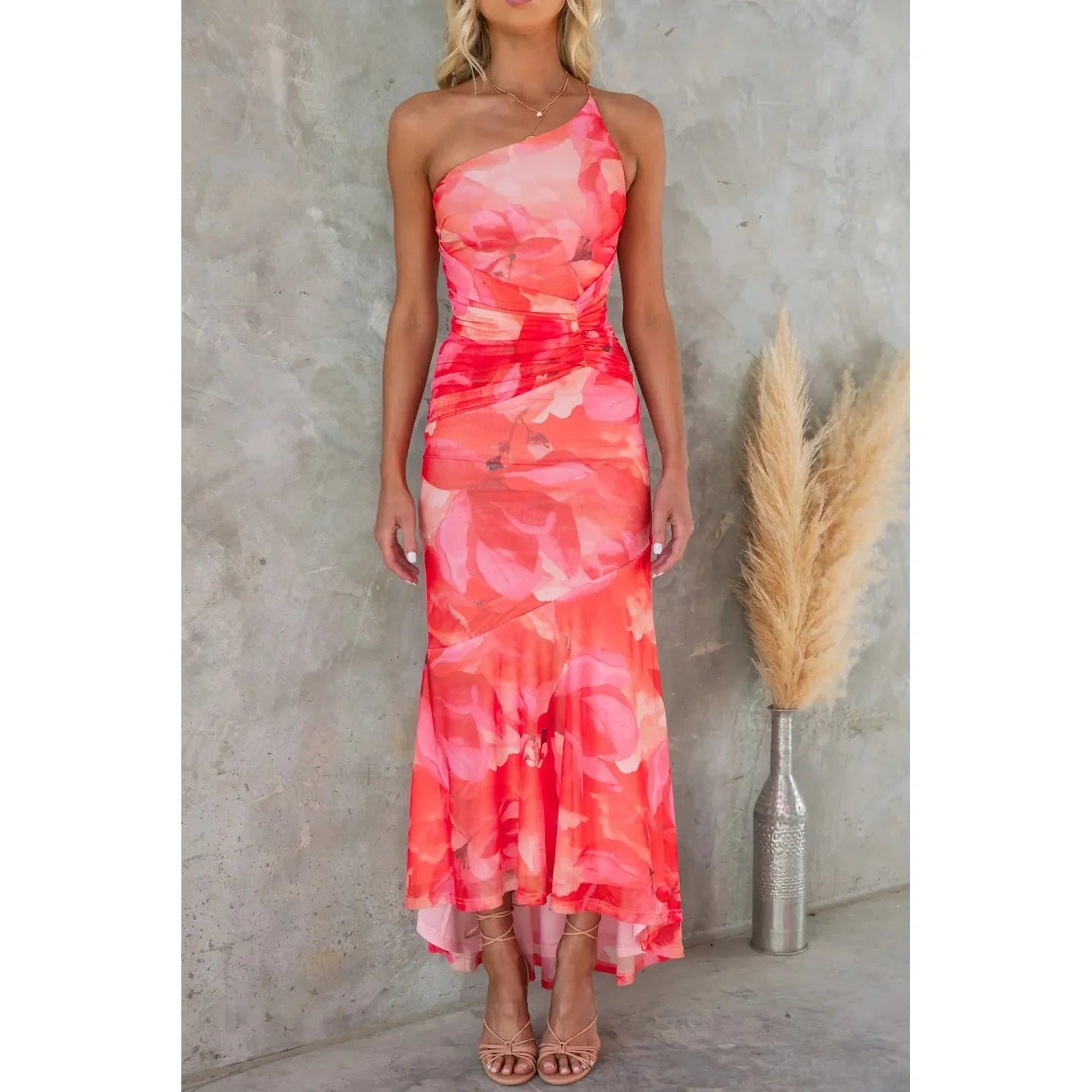 Floral one-shoulder dress in various colours, featuring a unique design and comfortable polyester fabric for effortless summer style.