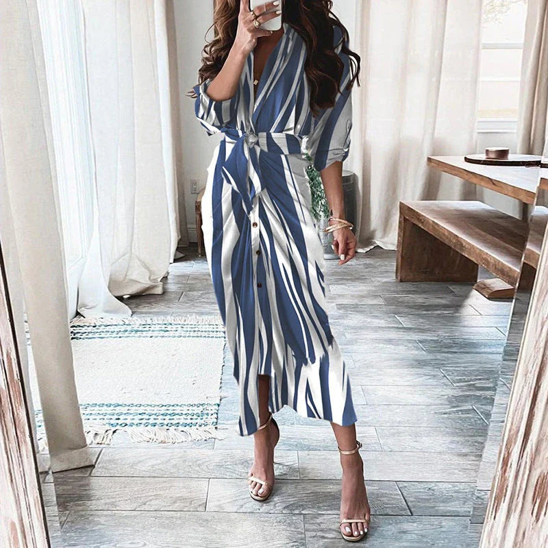 A beautiful floral wrap dress with lace-up detailing, featuring a deep V-neck and full-length skirt for a flattering, elegant look.