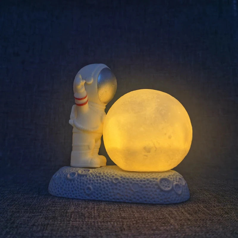 Astronaut-themed colour-changing night lamp with durable natural resin construction