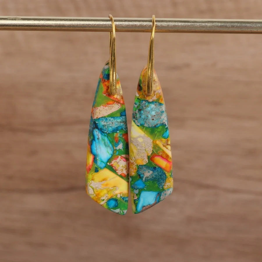 Geometric flower shape pendant earrings in copper with gold hooks, available in red, green, and blue.