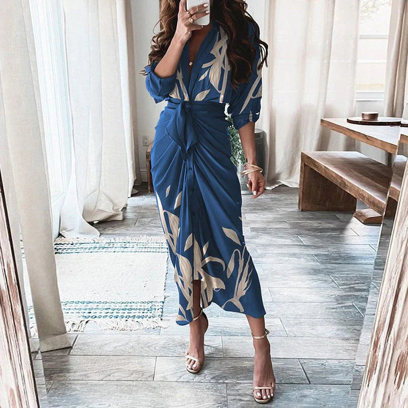 A beautiful floral wrap dress with lace-up detailing, featuring a deep V-neck and full-length skirt for a flattering, elegant look.