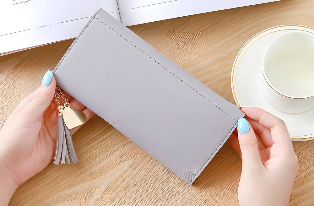 GEONYIEEK™ Women's Long Leather Wallet in various colours, featuring a sleek design, decorative tassel, and multiple storage compartments