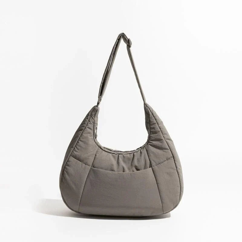Chic Half Moon Puffer Shoulder Bag in a stylish pink colour, featuring a unique design and practical features for the modern woman.