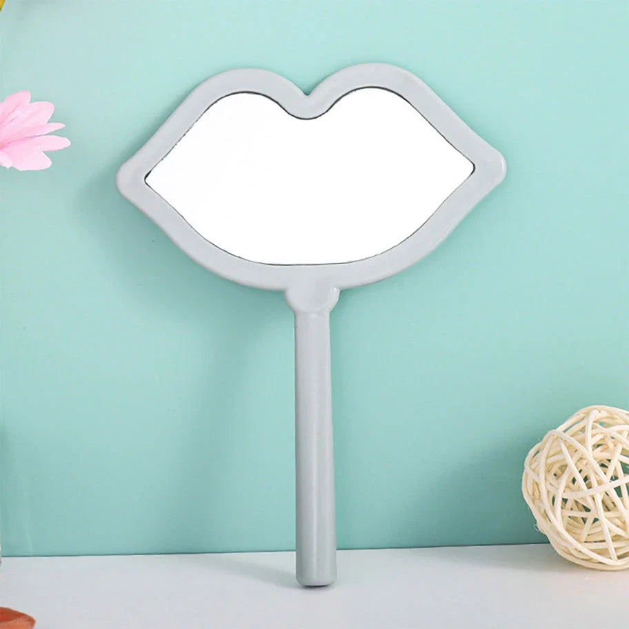 Lip-shaped handheld makeup mirror with a comfortable ergonomic handle for precise on-the-go touch-ups