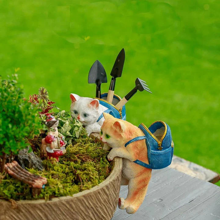 A charming resin cat figurine wearing a stylish backpack, serving as a unique garden decoration and practical storage solution.