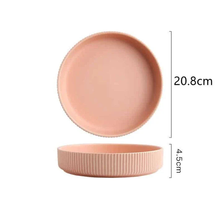 Candy-coloured ribbed ceramic tableware featuring plates, bowls, and other dining accessories in vibrant hues