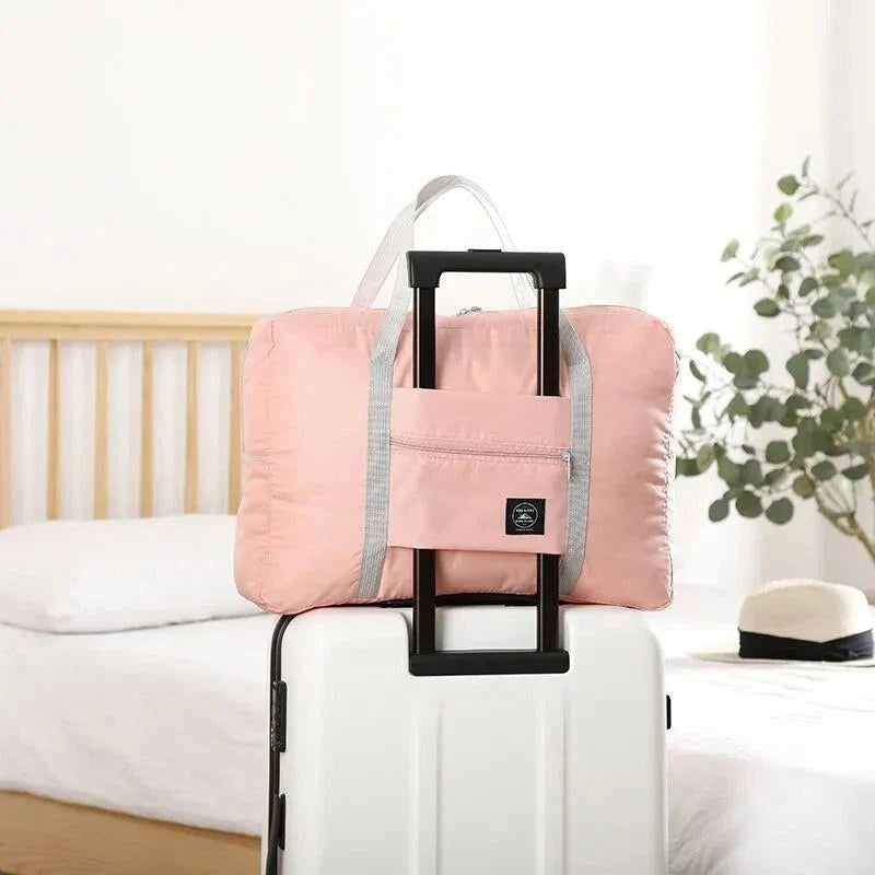 Premium foldable travel duffel bag in a solid colour design, with a large capacity and lightweight construction for women's travel needs.
