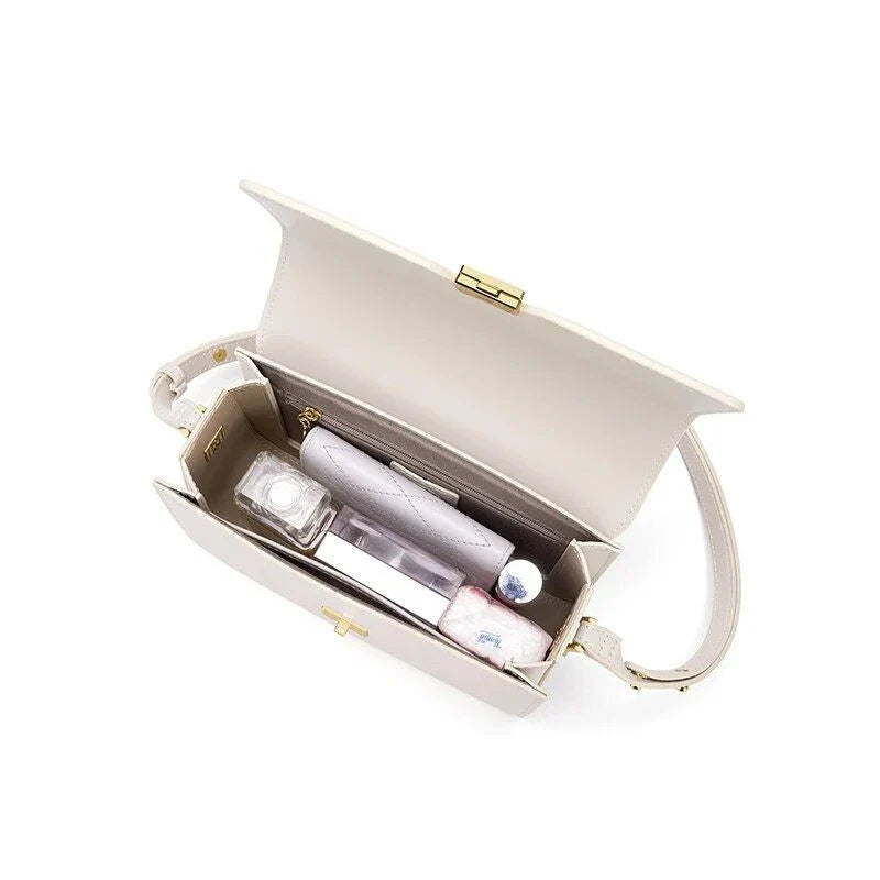 Stylish British-inspired leather shoulder and crossbody bag in black, tan, and navy colours