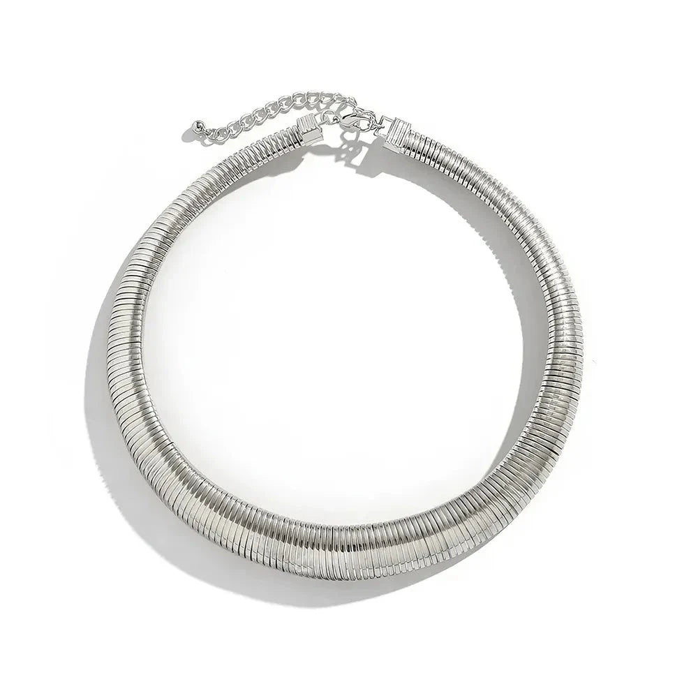 Captivating spiral chunky choker necklace in gold and silver colours, featuring a bold, geometric design for a unique, statement-making look.
