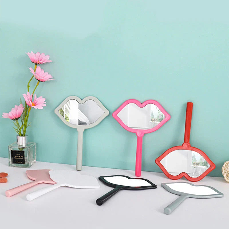 Lip-shaped handheld makeup mirror with a comfortable ergonomic handle for precise on-the-go touch-ups