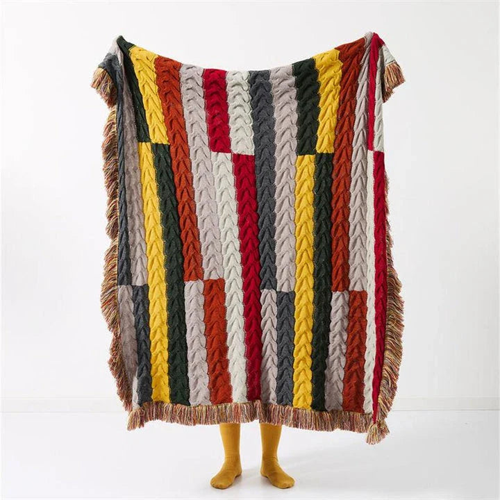 Elegant wool blanket with stylish plaid pattern and fringed tassels, perfect for cosy home decor and outdoor adventures.