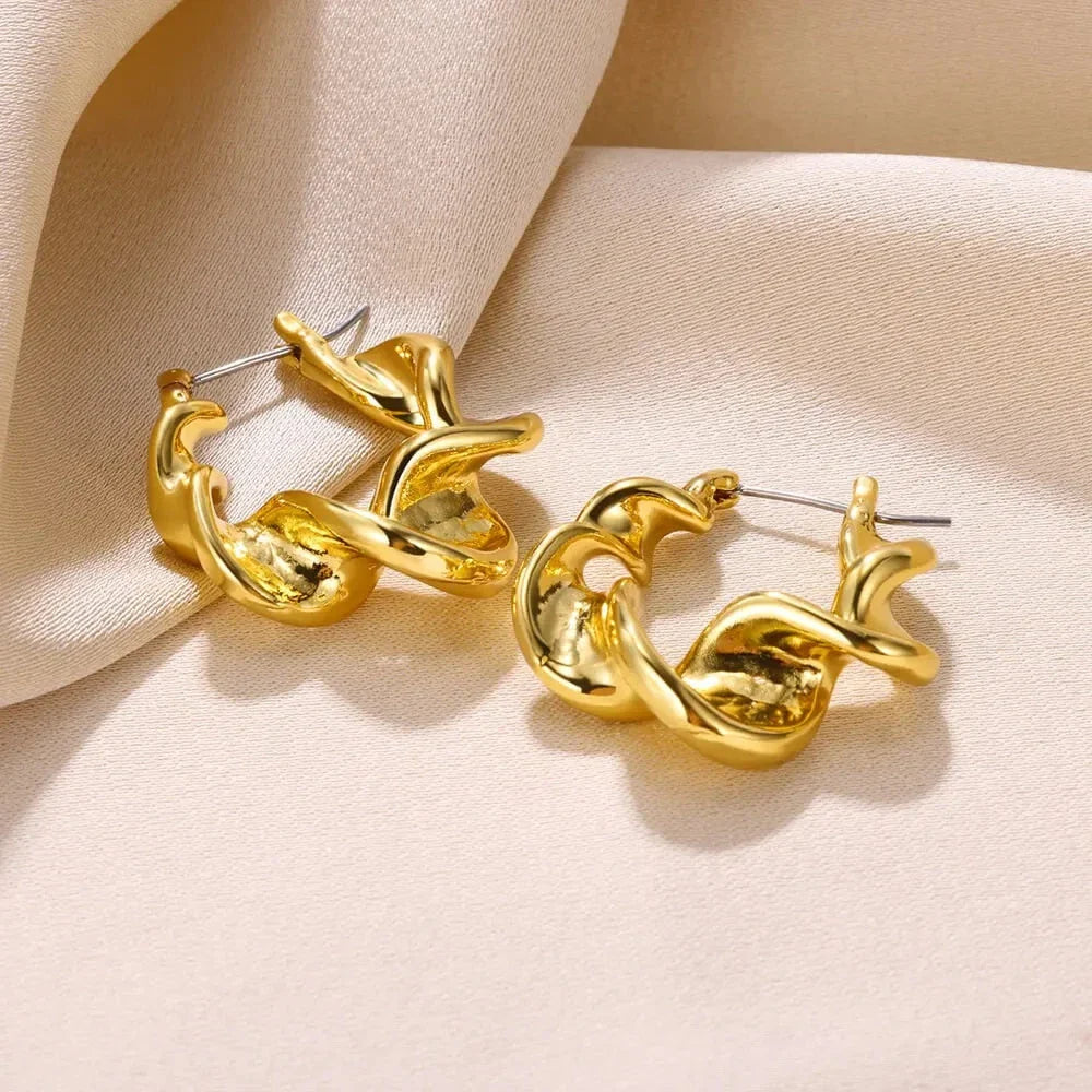 A pair of gold-toned stainless steel hoop earrings, showcasing a classic and sophisticated design