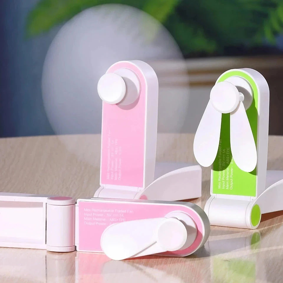 Compact rechargeable handheld fan in pink and green colours, providing powerful cooling on the move