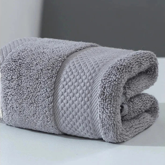 Premium 100% cotton face towel in blue, featuring a soft and absorbent design for daily facial cleansing and bathing