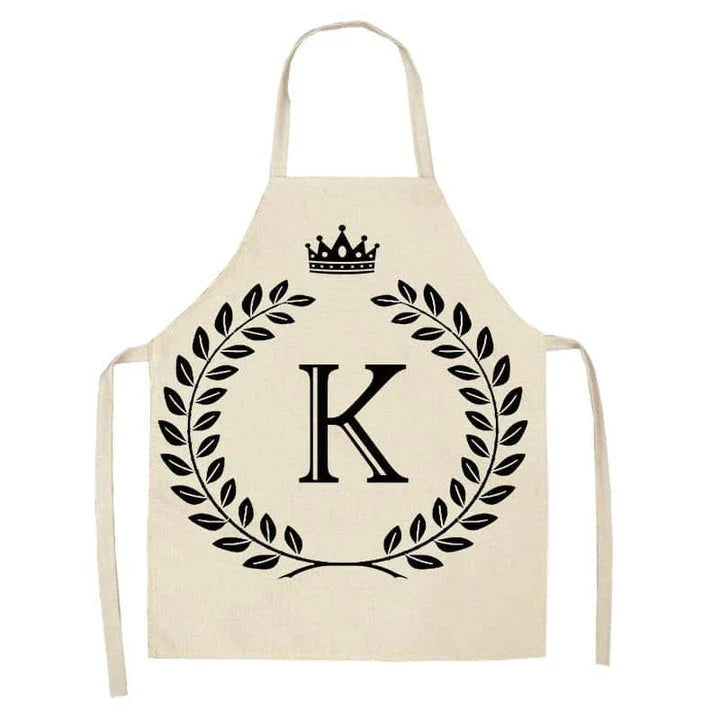 A high-quality kitchen apron featuring a charming crown and letter print design in a premium cotton and linen blend fabric.