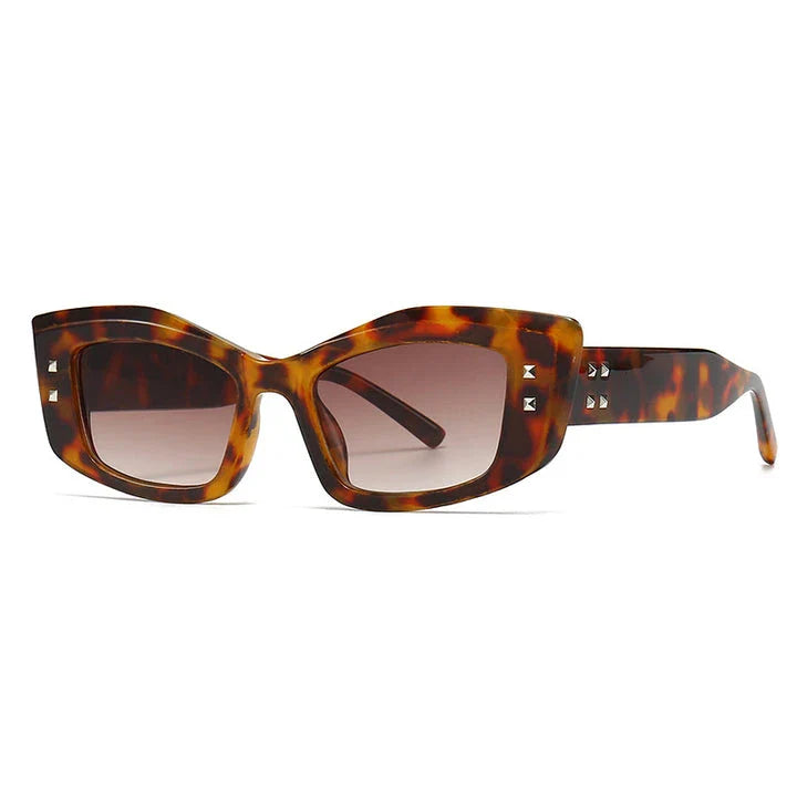 Retro cat eye sunglasses with rivet details, offering a stylish and protective eyewear solution.