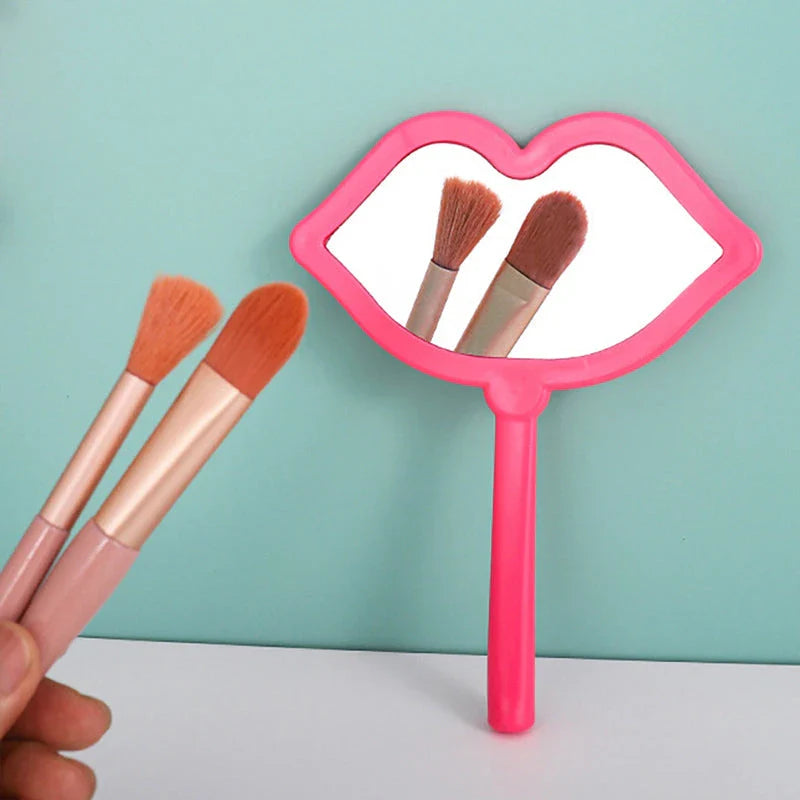 Lip-shaped handheld makeup mirror with a comfortable ergonomic handle for precise on-the-go touch-ups