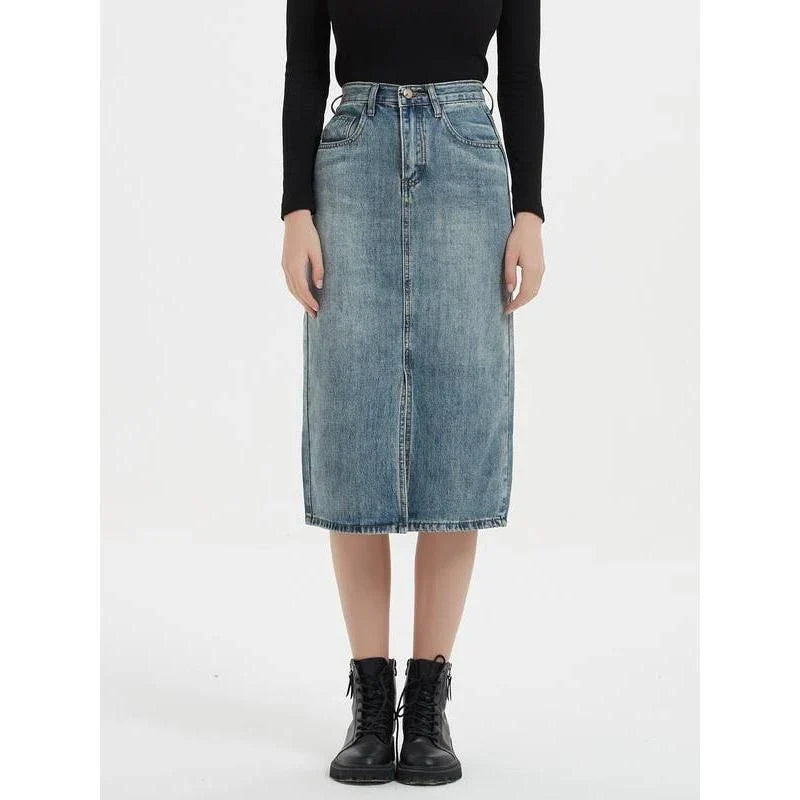 A high-waist denim pencil skirt with a classic A-line silhouette, perfect for the modern British woman.