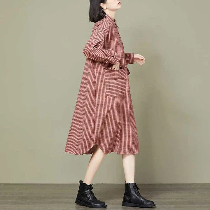 Plus-size women's dress with a striped pattern, asymmetric skirt, and long loose sleeves
