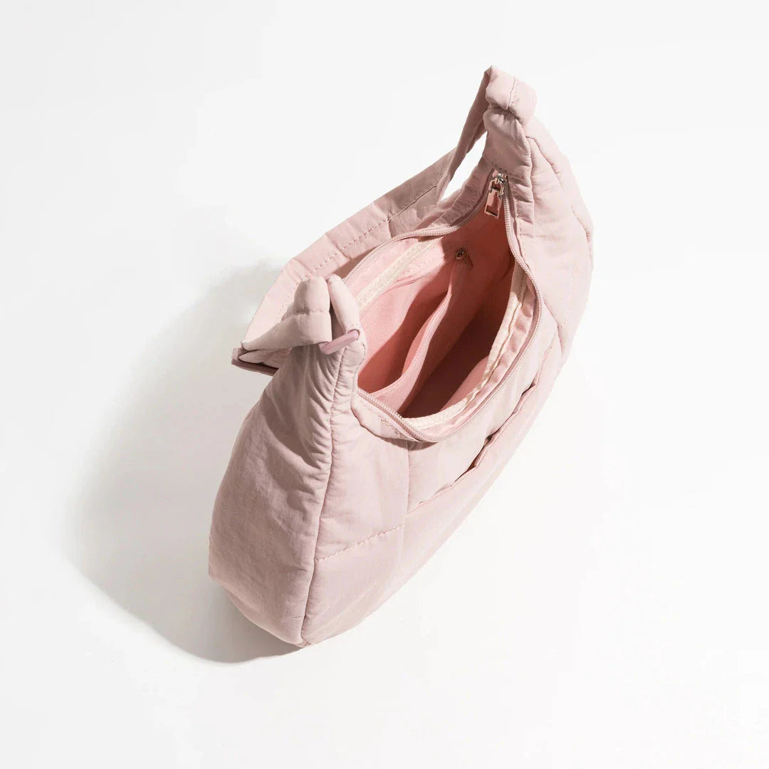 Chic Half Moon Puffer Shoulder Bag in a stylish pink colour, featuring a unique design and practical features for the modern woman.