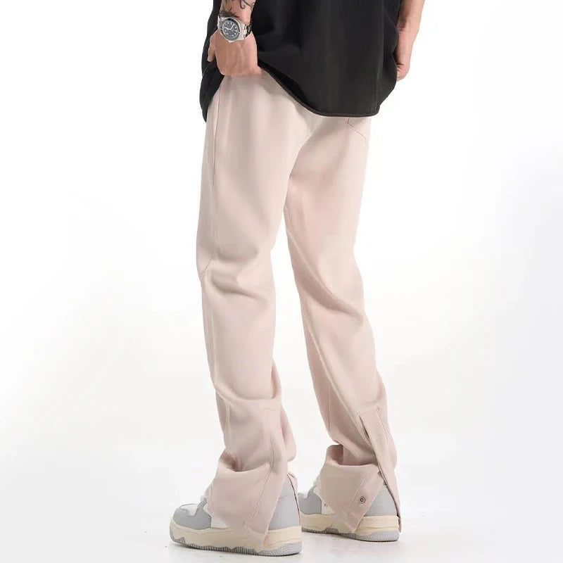Sophisticated retro-style casual suit trousers in black and apricot colours, featuring a sleek straight-leg silhouette and distinctive back slit