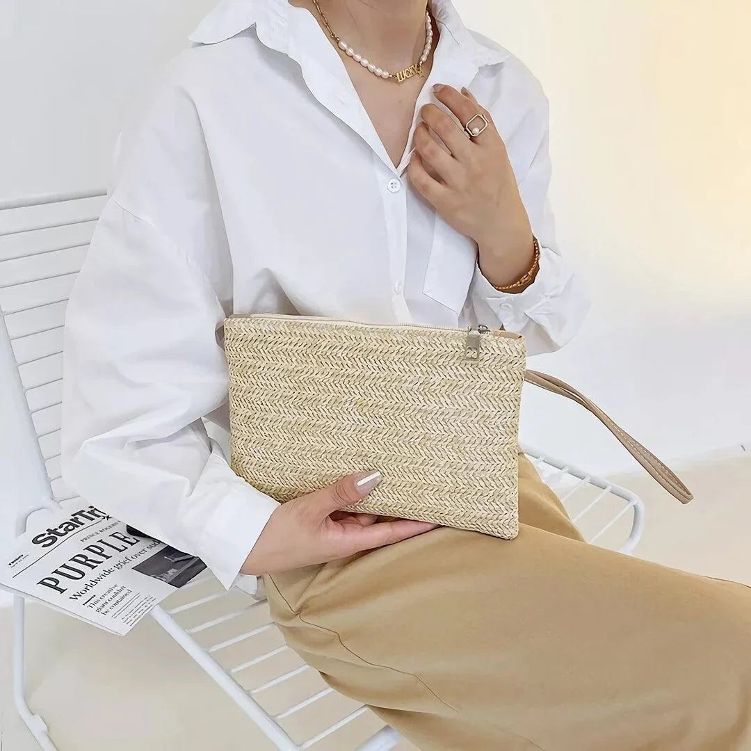 A natural straw-woven clutch with a zipper closure, perfect for summer outings in the UK.