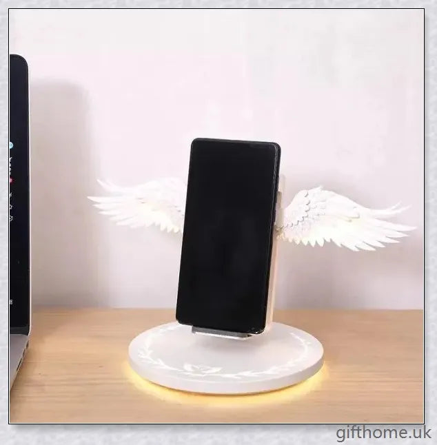 Elegant angel wings-shaped wireless charger with sleek, shiny surface and angelic lighting effect