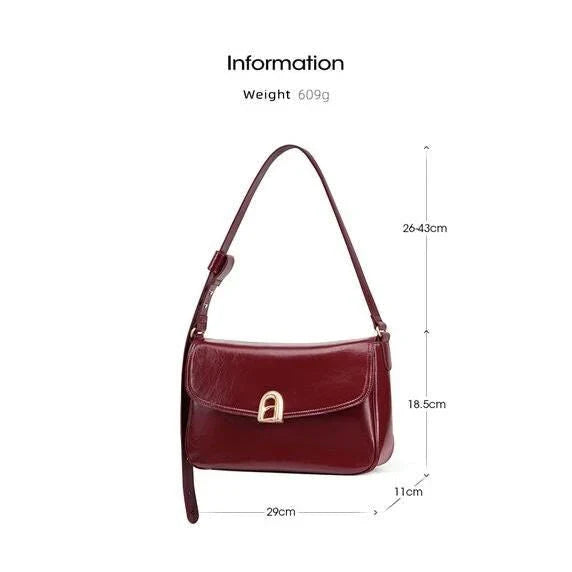 Stylish leather shoulder and crossbody bag in burgundy colour, with a square silhouette and sleek design