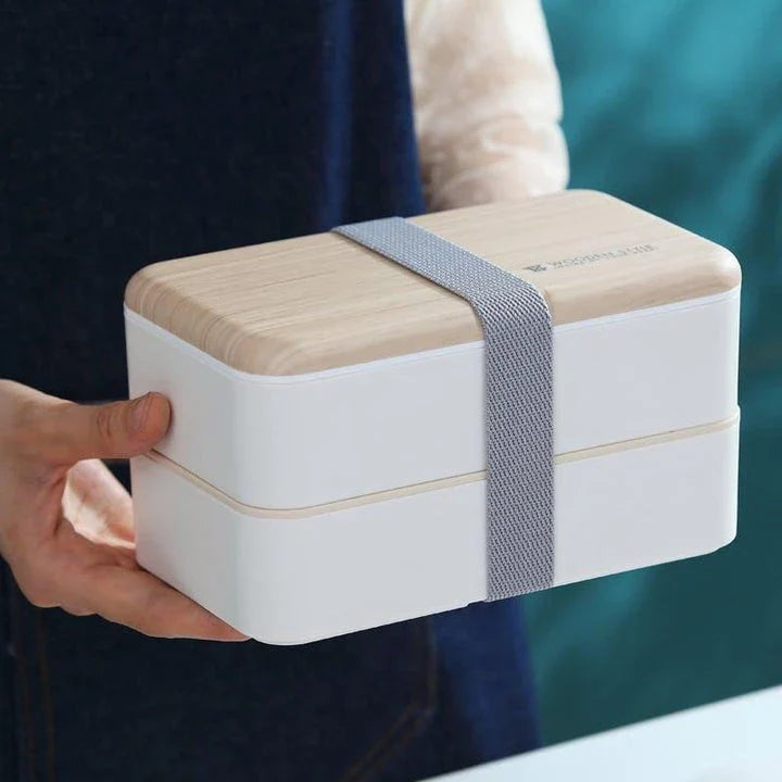 Premium BPA-free double-layer lunch box with stainless steel spoon and chopsticks, perfect for office, picnics, and on-the-go dining