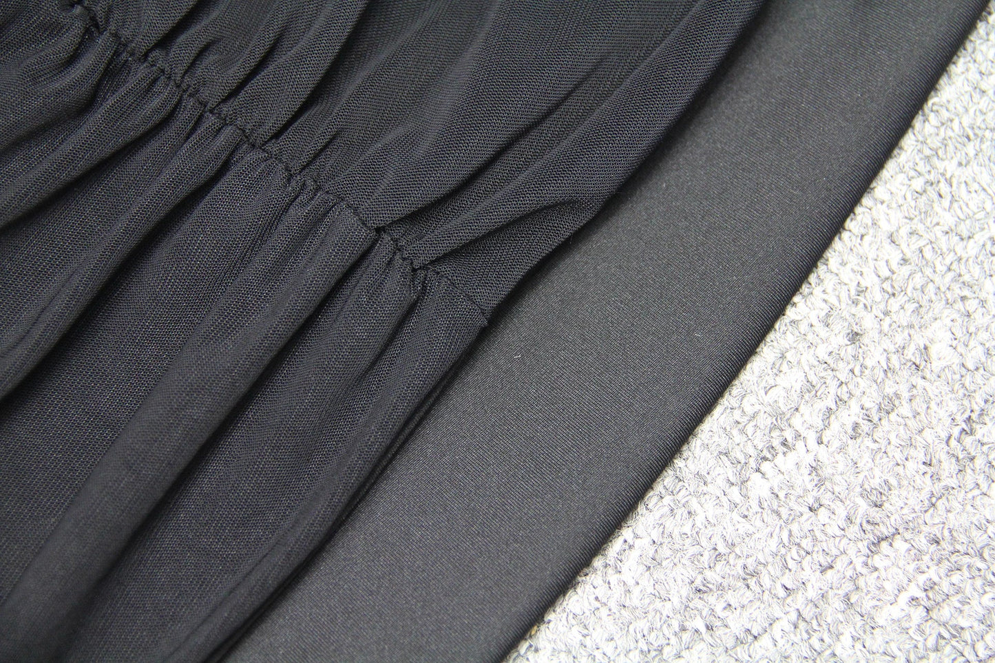 Elegant puff sleeve mesh dress with a flattering short, irregular skirt in white and black colours