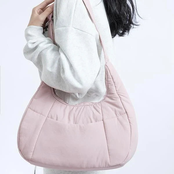Chic Half Moon Puffer Shoulder Bag in a stylish pink colour, featuring a unique design and practical features for the modern woman.