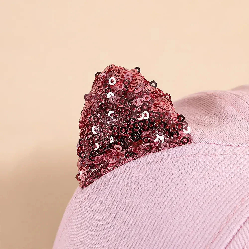 A playful, embroidered kids' baseball cap in a vibrant red panda colour, featuring a cute cartoon cat design and shimmering sequin accents.
