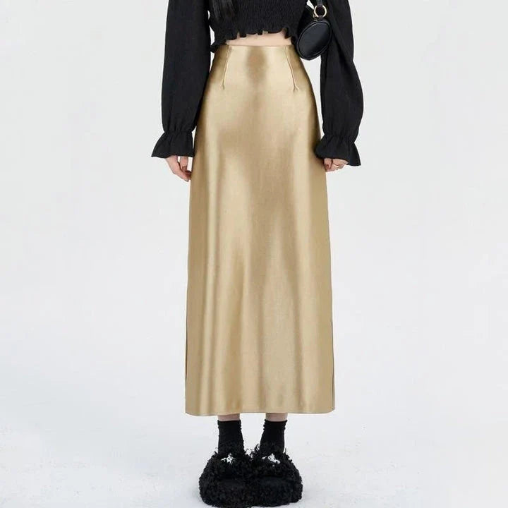 Luxurious silver satin maxi skirt with high-waist design and chic back split for elegant and versatile style.