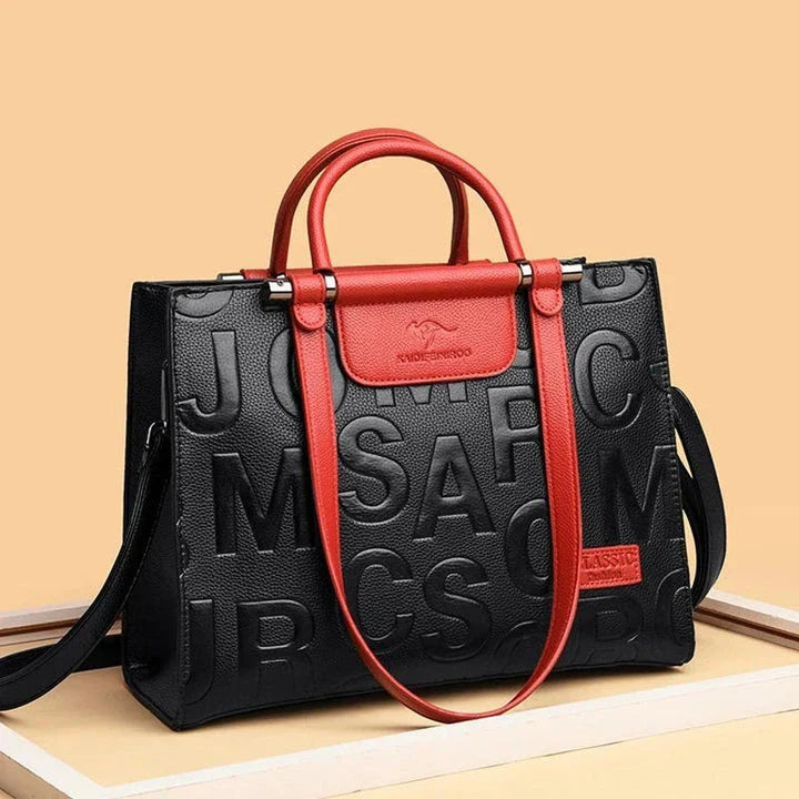 Sophisticated large leather tote bag with embossed lettering design, suitable for daily use and travel