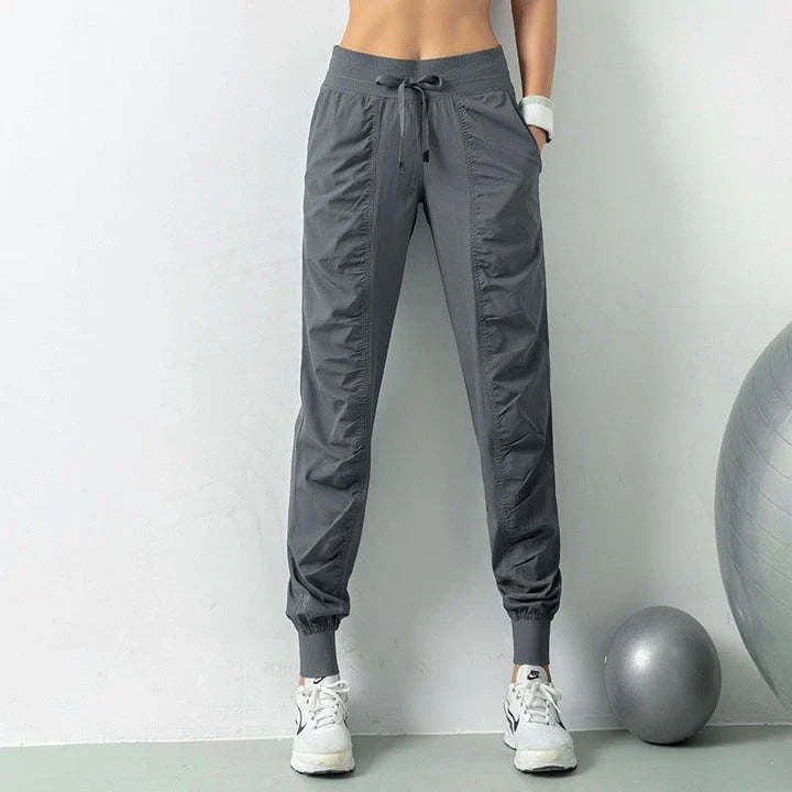 Premium women's sports trousers with drawstring waist and pockets, made of high-quality nylon fabric for comfort and versatility.